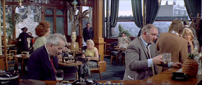 A still from the 1971 film Villain showing the interior with Richard Burton standing in the doorway.
