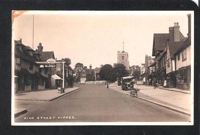 High Street, Pinner with the Queens Head on the left hand side. 