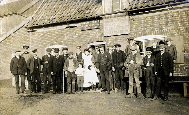 The Hawk, St Peter South Elmham, Suffolk - Wallace Tipple was the Licensee. He is the man in shirtsleeves standing behind his wife and 2 children centre of picture.